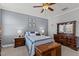 Comfortable bedroom featuring a fan, neutral color walls, bed, and traditional wood furniture at 24 Sweet Birch Row, Youngsville, NC 27596