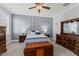 Comfortable bedroom featuring a fan, neutral color walls, bed, and traditional wood furniture at 24 Sweet Birch Row, Youngsville, NC 27596