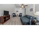 Spacious bonus room with comfortable seating, entertainment center, ceiling fan, and neutral carpeting at 24 Sweet Birch Row, Youngsville, NC 27596