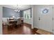 Traditional dining room featuring hardwood floors, a chandelier, and a window view of the outdoors at 24 Sweet Birch Row, Youngsville, NC 27596