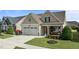 Charming single-Gathering home featuring a two-car garage, covered porch, and beautifully landscaped front yard at 24 Sweet Birch Row, Youngsville, NC 27596