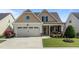 Charming single-Gathering home featuring a two-car garage, covered porch, and beautifully landscaped front yard at 24 Sweet Birch Row, Youngsville, NC 27596