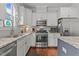 Modern kitchen featuring white cabinets, stainless steel appliances, and granite countertops at 24 Sweet Birch Row, Youngsville, NC 27596