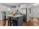Modern kitchen with white cabinets, stainless steel appliances, granite countertops, and a stylish center island at 24 Sweet Birch Row, Youngsville, NC 27596