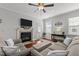 Bright living area with fireplace, door to backyard, and comfortable seating arrangement at 24 Sweet Birch Row, Youngsville, NC 27596