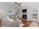 Cozy living room with a fireplace, hardwood floors, and a comfortable seating area at 24 Sweet Birch Row, Youngsville, NC 27596