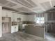 Spacious kitchen featuring white cabinets, a large island, and a window providing ample natural light at 240 Green Pines Estates Dr, Kenly, NC 27542