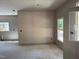 Bright living room with fresh drywall, concrete floor, and multiple windows offering natural light at 240 Green Pines Estates Dr, Kenly, NC 27542