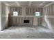 Large, open living room with fireplace feature and plenty of natural light from the two windows at 240 Green Pines Estates Dr, Kenly, NC 27542