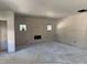 Unfinished living room with new drywall, concrete floor, and two windows for plenty of natural light at 240 Green Pines Estates Dr, Kenly, NC 27542