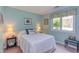 Cozy bedroom with a queen bed, bedside tables with lamps, and a sunny window with curtains at 313 Helmsdale Dr, Chapel Hill, NC 27517