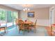 Cozy dining room with a round wooden table, comfortable chairs, and sliding glass doors leading to an outdoor area at 313 Helmsdale Dr, Chapel Hill, NC 27517
