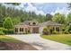 Charming yellow home with a well-manicured lawn, inviting driveway, and attached garage, perfect for suburban living at 313 Helmsdale Dr, Chapel Hill, NC 27517