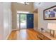 Bright foyer with hardwood floors, a high ceiling, and a blue front door with an open view to the outside at 313 Helmsdale Dr, Chapel Hill, NC 27517