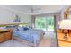 Spacious main bedroom features a king bed, a ceiling fan, and access to the backyard patio at 313 Helmsdale Dr, Chapel Hill, NC 27517