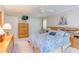 Bright main bedroom offers a king bed, ceiling fan, a wall-mounted television, and neutral carpeting at 313 Helmsdale Dr, Chapel Hill, NC 27517