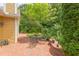 Secluded brick patio with space for outdoor dining surrounded by garden at 313 Helmsdale Dr, Chapel Hill, NC 27517