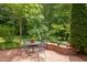 Charming brick patio with outdoor seating, perfect for relaxing or entertaining in a garden setting at 313 Helmsdale Dr, Chapel Hill, NC 27517