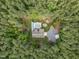Aerial view of a property with a pool, fire pit, home, and lush greenery at 3653 Range Rd, Stem, NC 27581