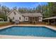 Backyard features a large in-ground pool and an expansive wooden deck, perfect for outdoor relaxation and entertainment at 3653 Range Rd, Stem, NC 27581
