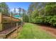 Manicured lawn and split rail fence, providing a serene outdoor space at 3653 Range Rd, Stem, NC 27581