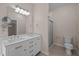 Bathroom with double sinks, marble countertops, and a glass shower at 3653 Range Rd, Stem, NC 27581