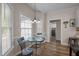 Breakfast area with wood floors, natural light, and a view of the laundry room at 3653 Range Rd, Stem, NC 27581