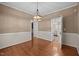Dining room with hardwood floors, chandelier, neutral colors and a view of kitchen at 3653 Range Rd, Stem, NC 27581
