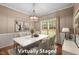 A virtually staged dining room with a marble table, nice lighting, and neutral colors at 3653 Range Rd, Stem, NC 27581