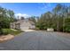 Exterior of a well-maintained home featuring a long, gravel driveway at 3653 Range Rd, Stem, NC 27581