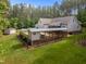 Expansive deck features a covered area, connecting the home to the pool and backyard, great for outdoor living at 3653 Range Rd, Stem, NC 27581