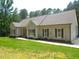 Inviting home with a green lawn, mature trees, and classic shutters, complemented by a well-maintained facade at 3653 Range Rd, Stem, NC 27581