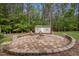 Fire pit area with seating and outbuilding, perfect for gatherings and outdoor enjoyment at 3653 Range Rd, Stem, NC 27581