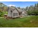 Traditional style home with well-maintained yard and an outbuilding to the side at 3653 Range Rd, Stem, NC 27581