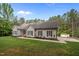 Traditional home featuring manicured lawn, shutters, and mature trees at 3653 Range Rd, Stem, NC 27581