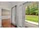 Hallway featuring hardwood floors with views of the backyard and an adjacent room at 3653 Range Rd, Stem, NC 27581