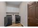 Laundry room with washer, dryer, and cabinets for storage at 3653 Range Rd, Stem, NC 27581