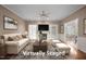 Staged living room featuring neutral furniture, fireplace and access to the dining room at 3653 Range Rd, Stem, NC 27581