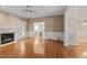 Open living room boasting hardwood floors, a fireplace, and seamless flow into the adjacent kitchen at 3653 Range Rd, Stem, NC 27581