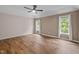 Bedroom with a ceiling fan, hardwood floors, and two windows at 3653 Range Rd, Stem, NC 27581