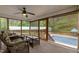 Relaxing screened porch with comfortable seating, offering serene views of the backyard and pool at 3653 Range Rd, Stem, NC 27581
