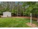 Backyard featuring shed with extra storage and adjacent tree covered area at 3653 Range Rd, Stem, NC 27581