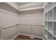 Walk-in closet with custom shelving and wooden rods at 3653 Range Rd, Stem, NC 27581