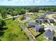 An aerial view of a real estate, highlighting a pond with lush greenery and surrounding residences at 45 Iris Dr, Youngsville, NC 27596
