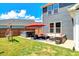 A patio featuring a hot tub, outdoor furniture under a red umbrella, and lush green grass at 45 Iris Dr, Youngsville, NC 27596