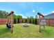 Inviting backyard featuring a fire pit, swing, and comfortable hanging chair for outdoor relaxation at 45 Iris Dr, Youngsville, NC 27596