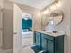 Modern bathroom with a double sink vanity, tile floor and entry to the main bedroom at 45 Iris Dr, Youngsville, NC 27596