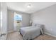 Bright bedroom featuring soft carpet, a large window and neutral decor at 45 Iris Dr, Youngsville, NC 27596
