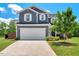 Charming two-story home featuring a two-car garage, a well-manicured lawn, and classic architectural details at 45 Iris Dr, Youngsville, NC 27596
