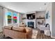 Bright living room featuring a fireplace, comfortable seating, natural light, and a seamless flow into other areas of the home at 45 Iris Dr, Youngsville, NC 27596